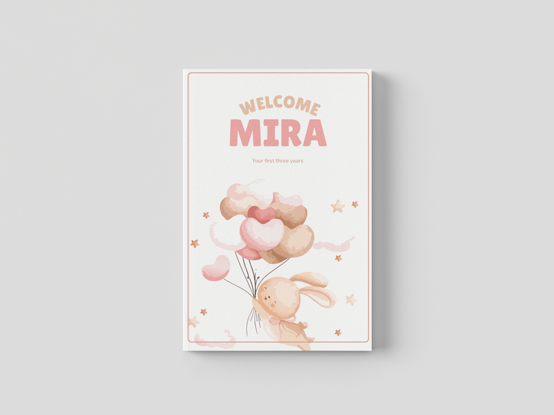 Open personalized baby memory book showing milestone chapter pages