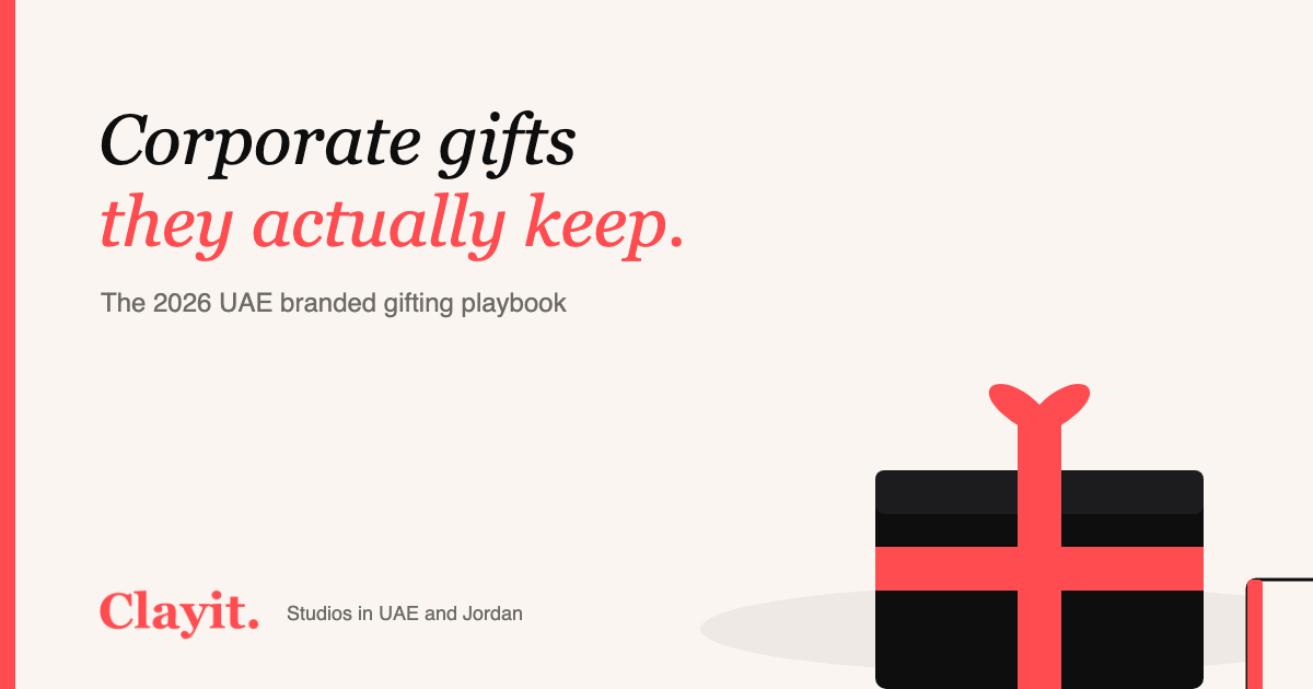 Branded corporate gift box with ribbon, notebook and coffee in Clayit. cream and coral palette with the Clayit logo
