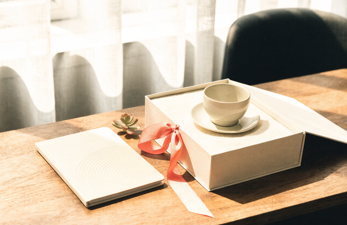 Premium branded corporate gift box with a coral ribbon, notebook and coffee, by Clayit. in the UAE