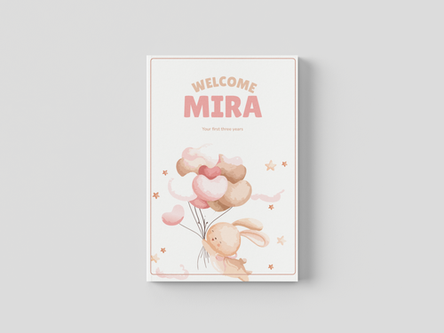 Open personalized baby memory book showing milestone chapter pages